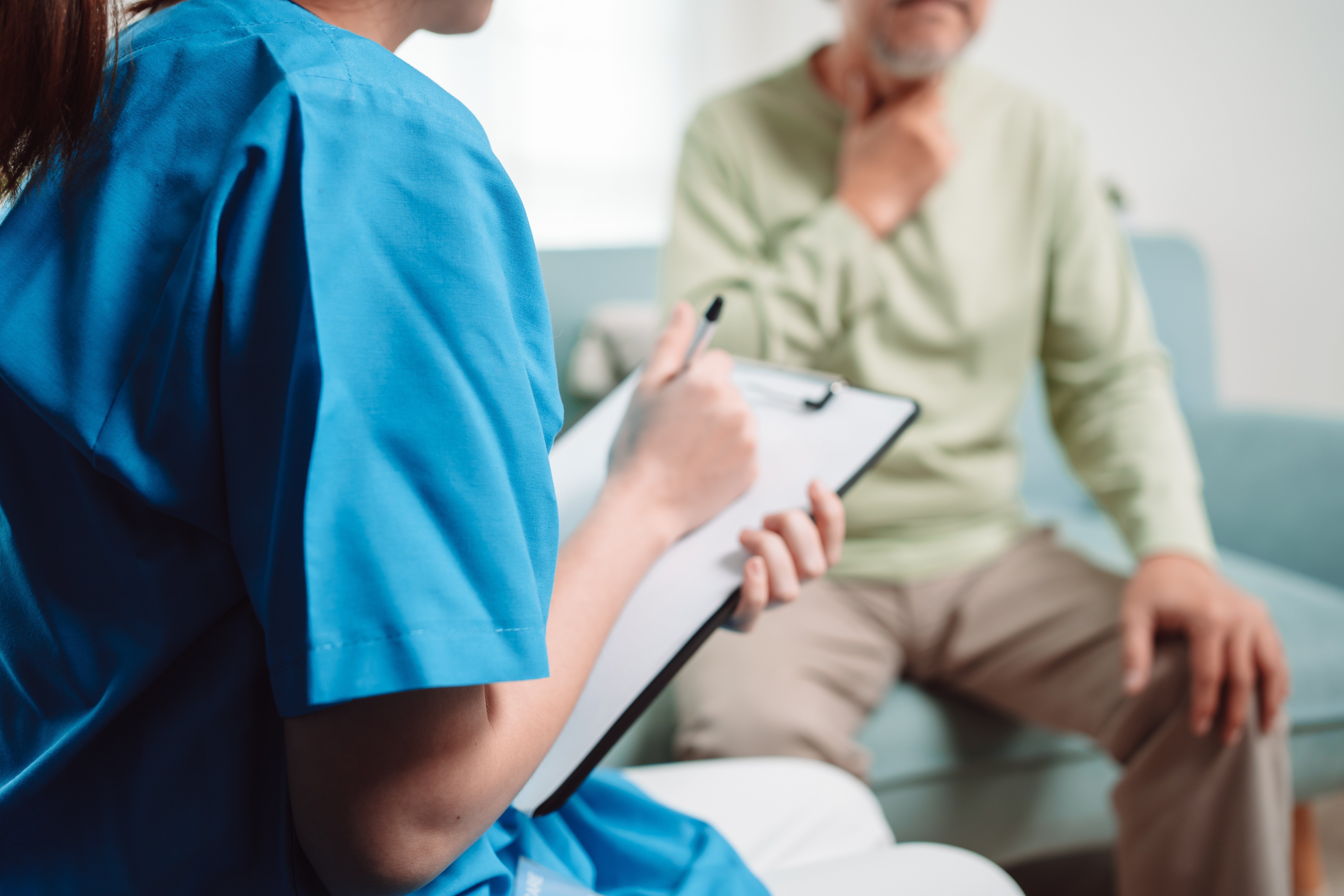 Senior being assisted by a healthcare professional.