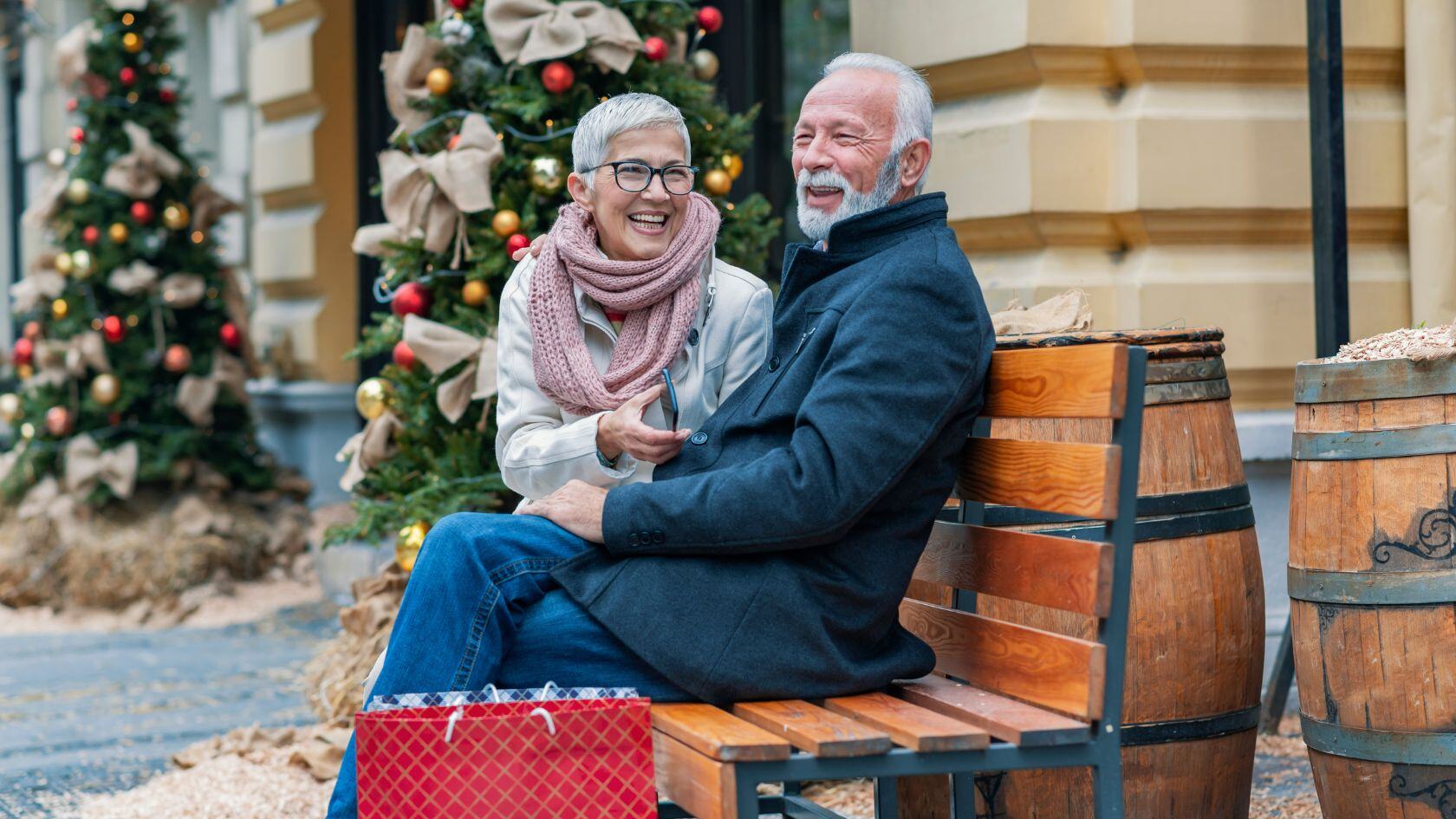 happy senior couple doing holiday shopping