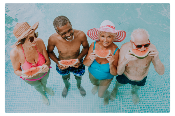 Retirees enjoying the summer in a pool.