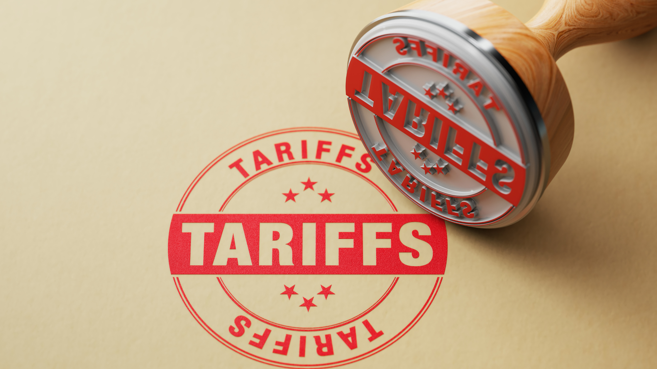 A red rubber stamp labeled "TARIFFS" presses down on a piece of paper, symbolizing economic policy decisions. This image represents how tariffs—by raising the cost of imported goods—can impact inflation, investment returns, and ultimately retirees' purchasing power and financial security.